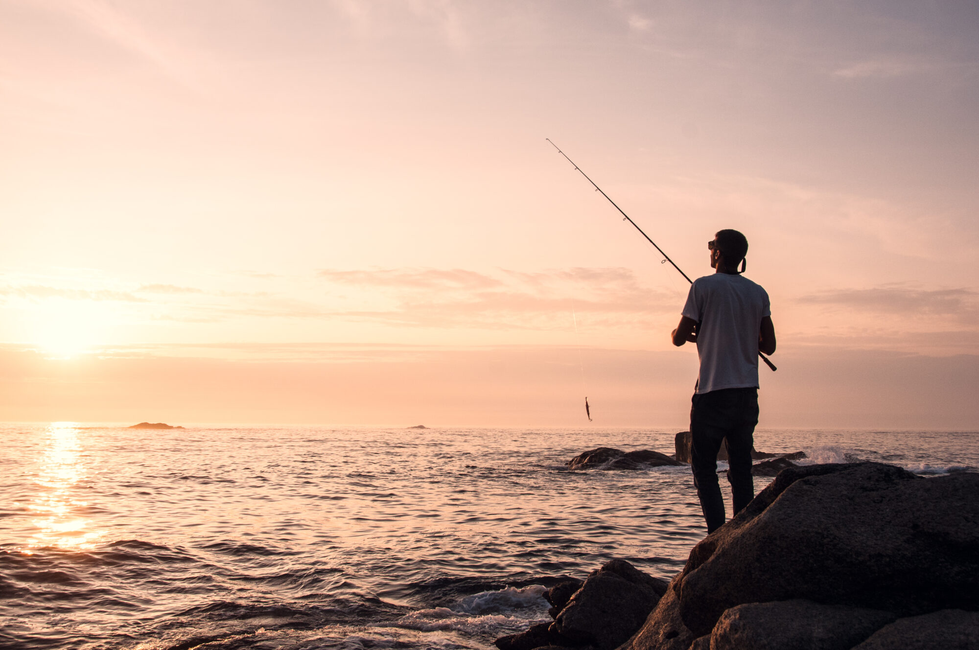 Silhouette,Of,A,Young,Man,Fishing,,Spining,Style,,From,The